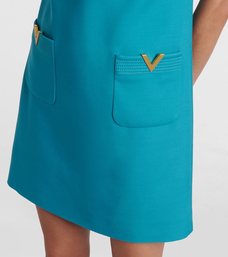 Valentino teal mini dress with a gold V pocket.