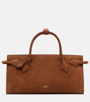 Brown suede tote bag with a leather handle and tie closure.