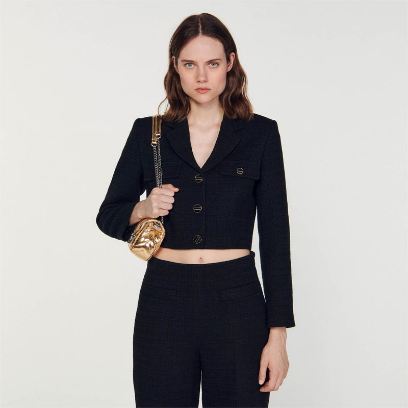 Black tweed blazer and trousers set with gold buttons.