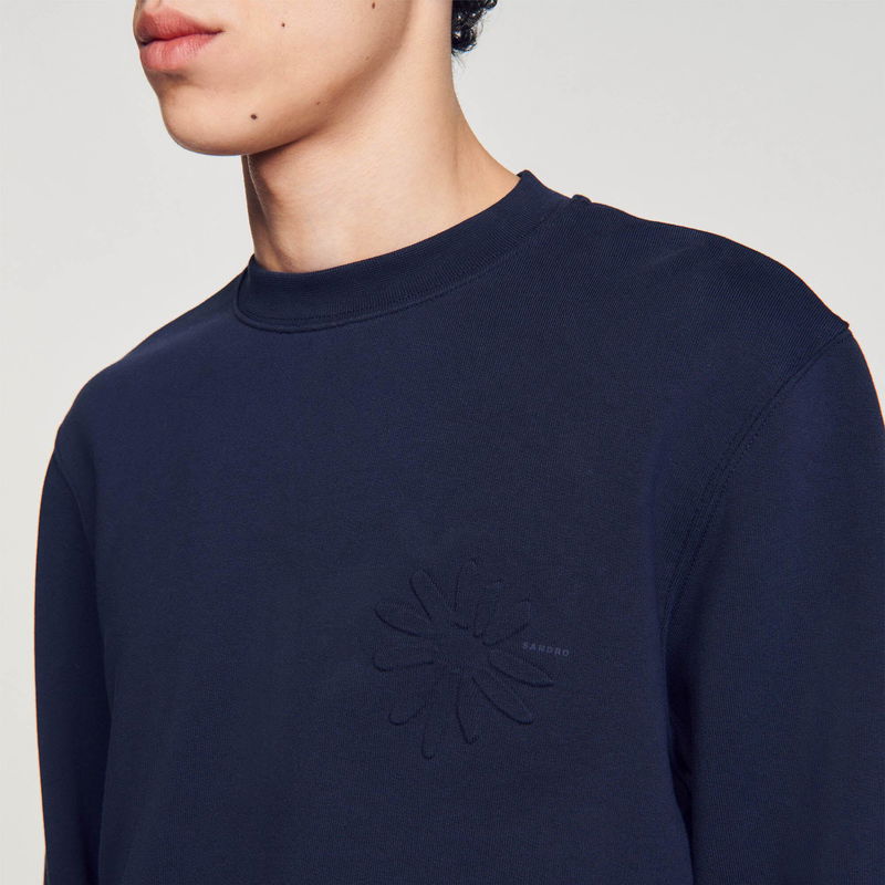 Dark blue SANDRO sweatshirt with a floral embroidery detail.
