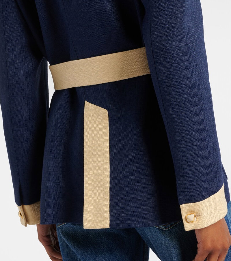 Navy blue blazer with a cream-colored belt and cuffs.