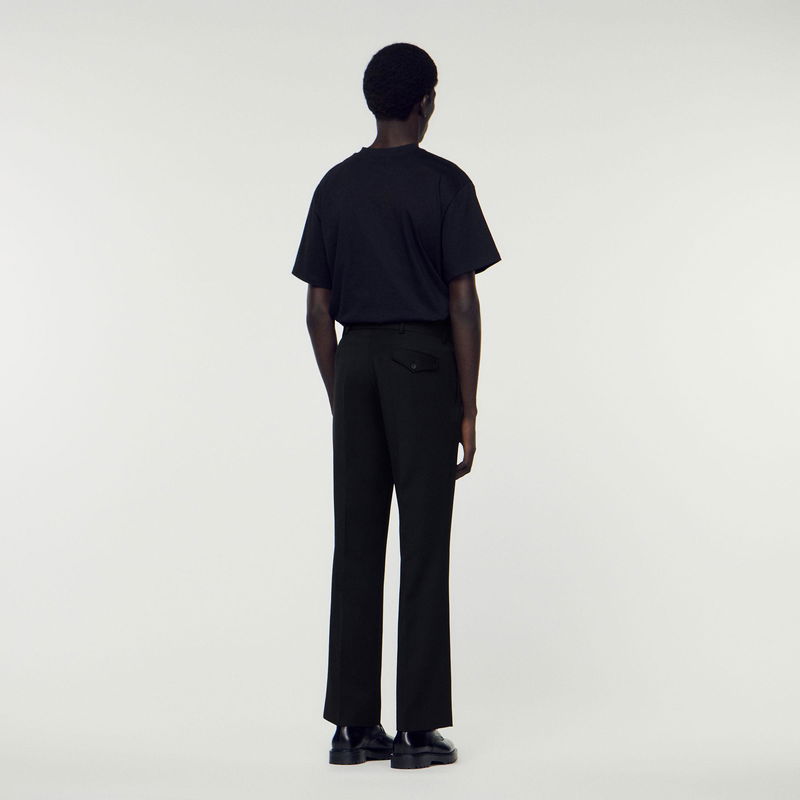 Black trousers and t-shirt on a model, back view