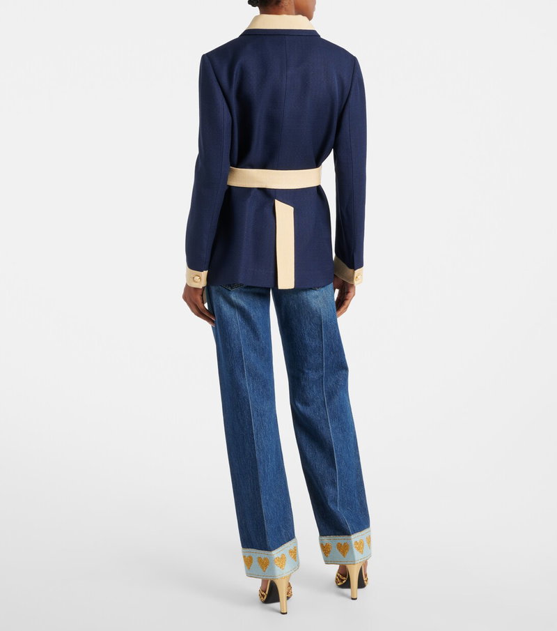 Valentino navy blazer with gold buttons and a beige belt.