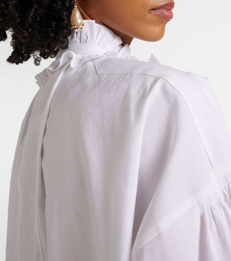 Valentino white blouse with puffed sleeves and pearl earrings