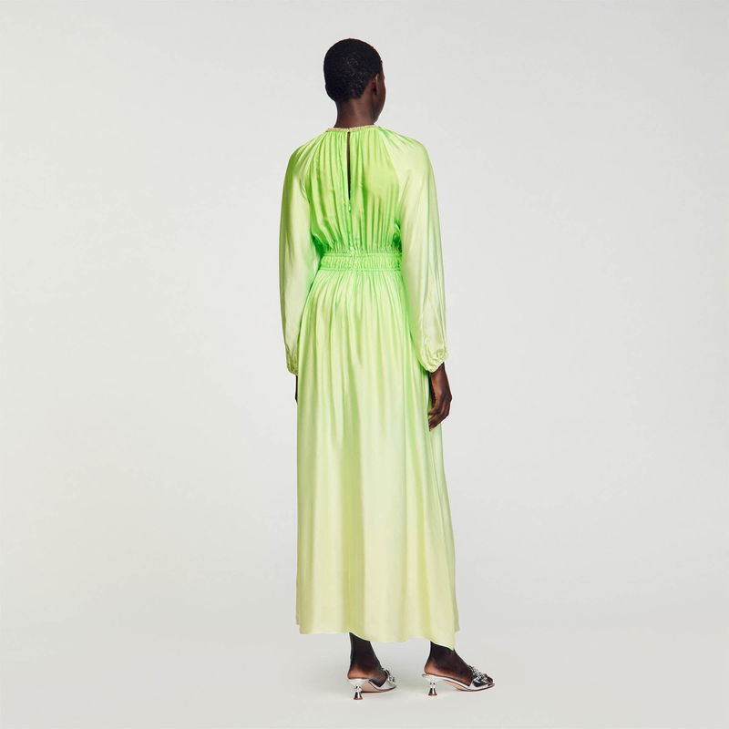Green satin midi dress with puffed sleeves and a low back.