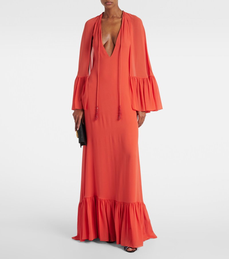 Valentino orange maxi dress with a cowl neck and tiered skirt.
