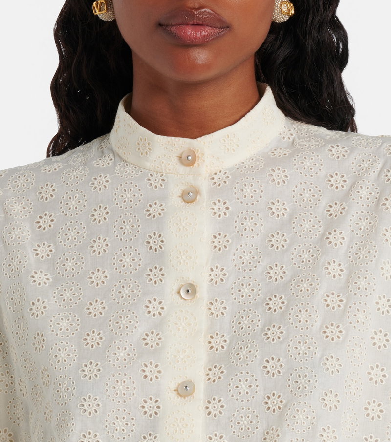 White embroidered blouse with floral detailing.