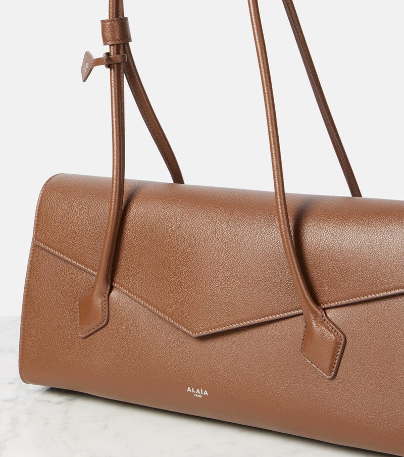 Brown leather shoulder bag with leather handles.