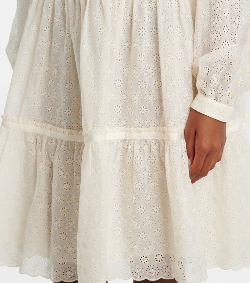 Off-white eyelet midi dress with ruffled tiers and sleeves.