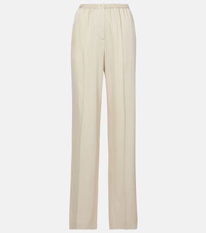 Cream-colored wide-leg trousers with pleats.