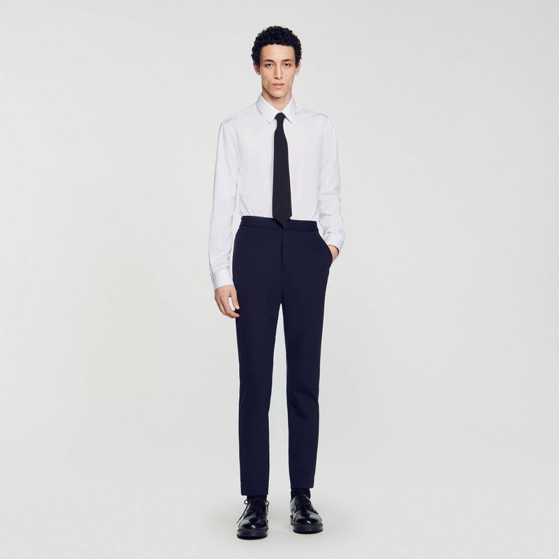 Sandro man in a black suit and tie
