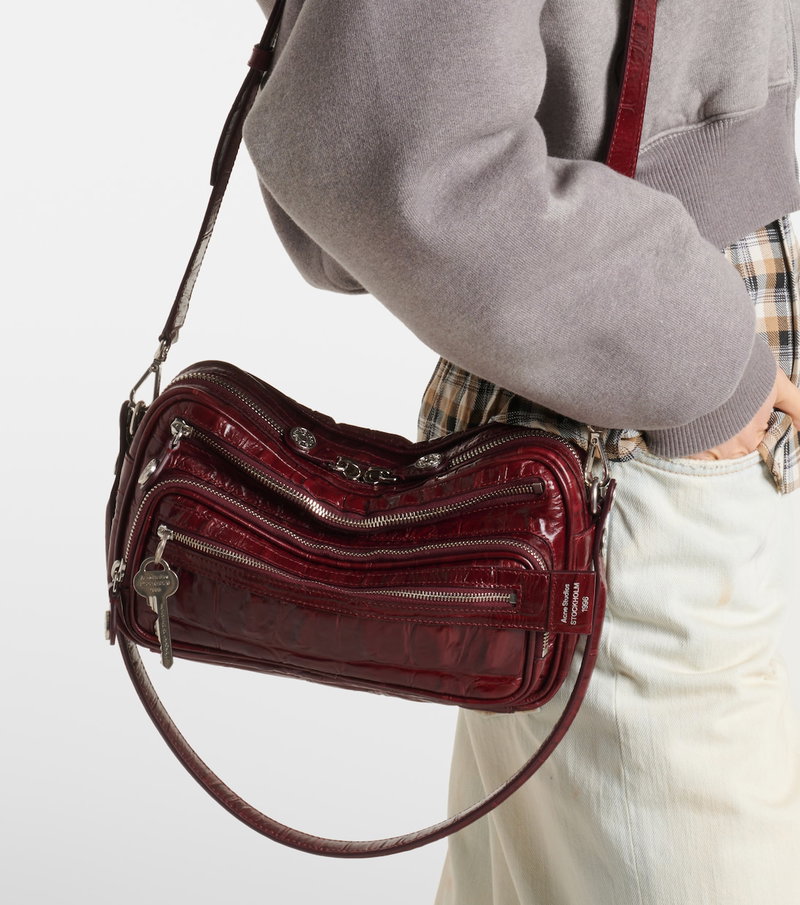 Red crocodile-textured crossbody bag with shoulder strap.