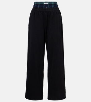 Black wide-leg trousers with a green and blue plaid cuff.