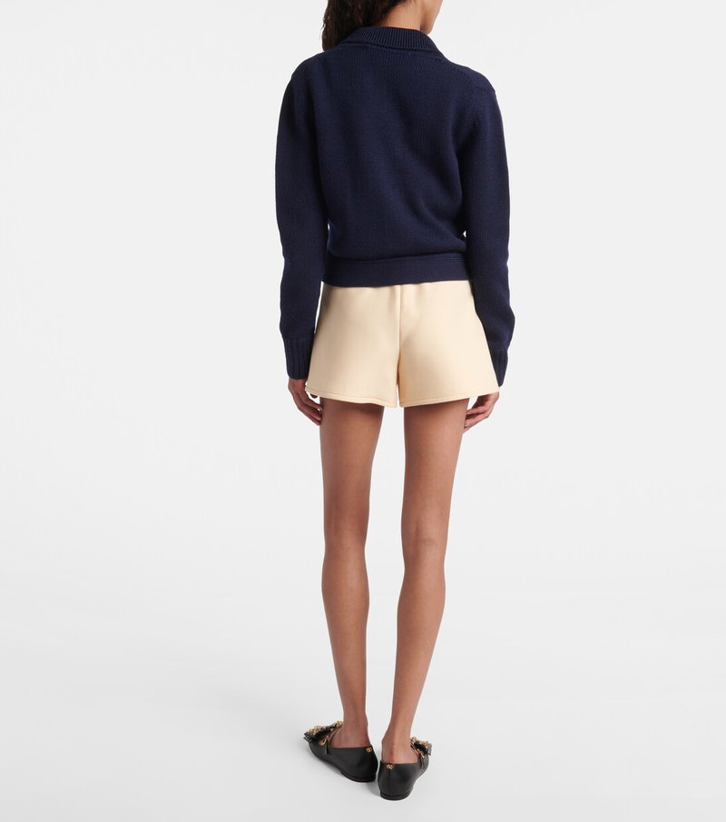 Valentino navy cable-knit sweater and blush shorts