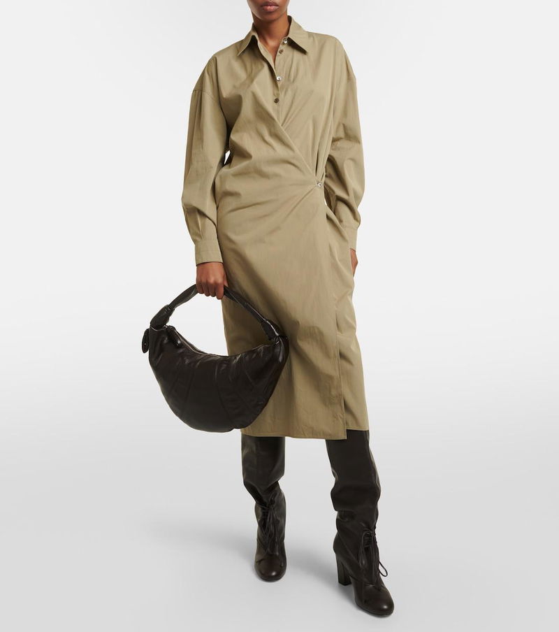 Olive linen dress with a curved wrap detail, held with a black leather handbag and paired with tall boots.