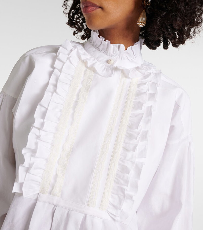 White ruffled blouse with lace detailing, worn by a model.