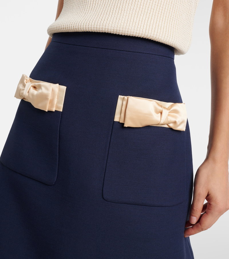 Navy satin skirt with cream bows and pockets