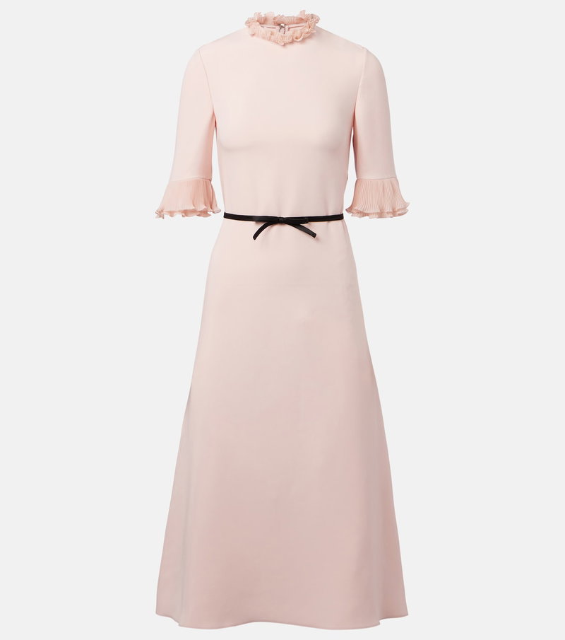 Pink ribbed dress with ruffled neckline and pleated sleeves.