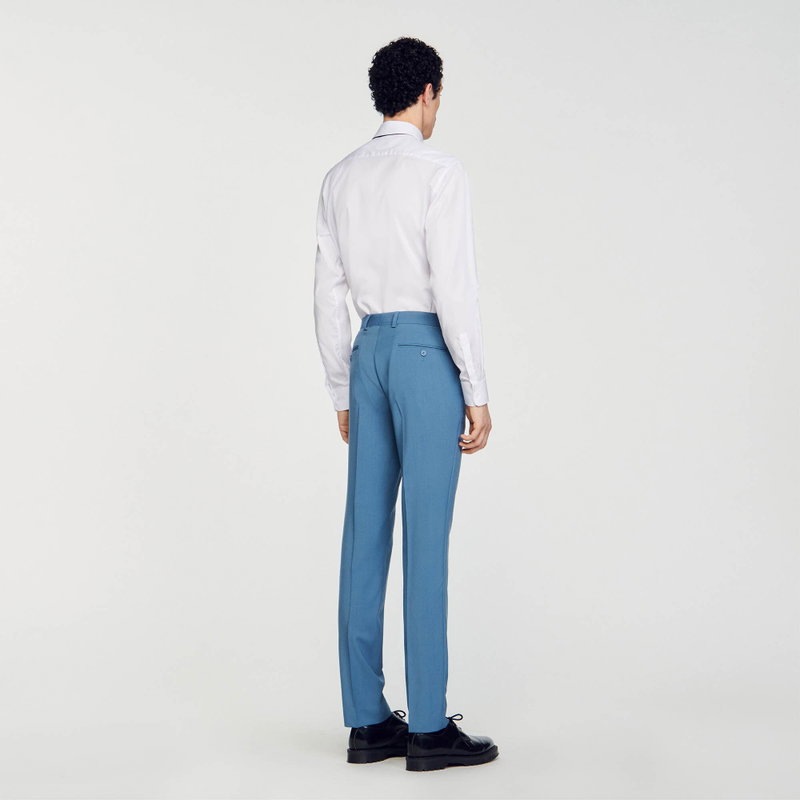 SANDRO - Man in blue suit trousers and white shirt
