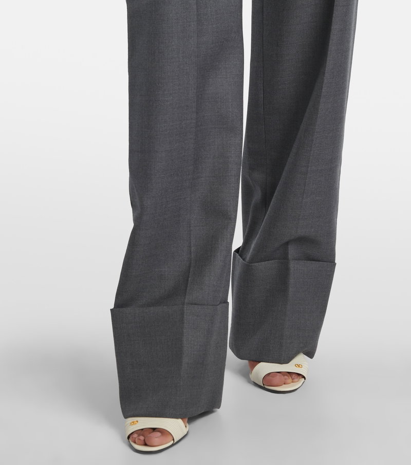 Gray wool trousers with gold hardware, paired with sandals.