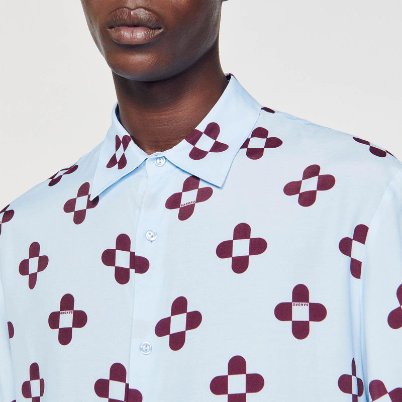 Blue shirt with a diamond-shaped floral pattern in dark red.