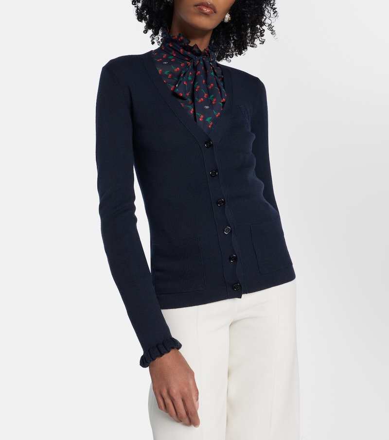 Dark blue cardigan with a cherry print scarf.