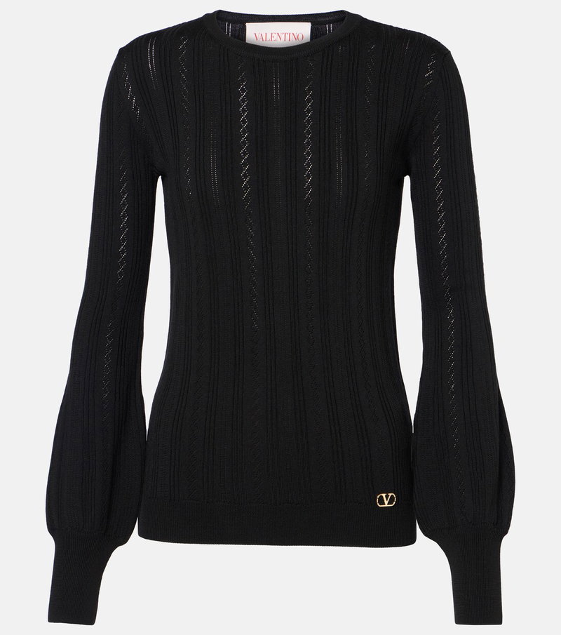 Black ribbed knit sweater with balloon sleeves and a gold Valentino logo.