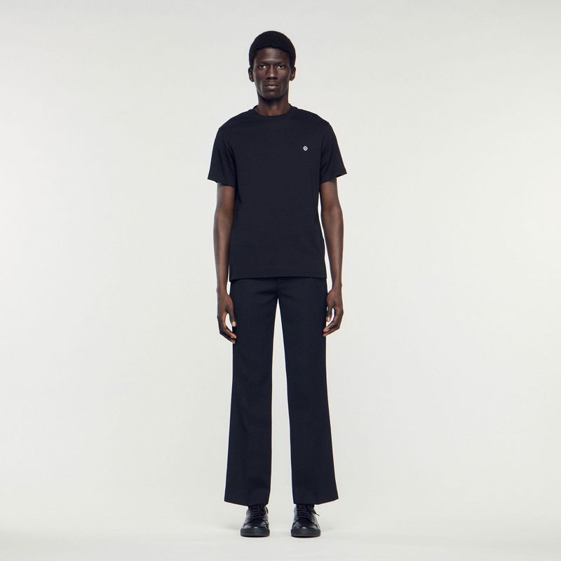 Black SANDRO t-shirt and trousers on a model.