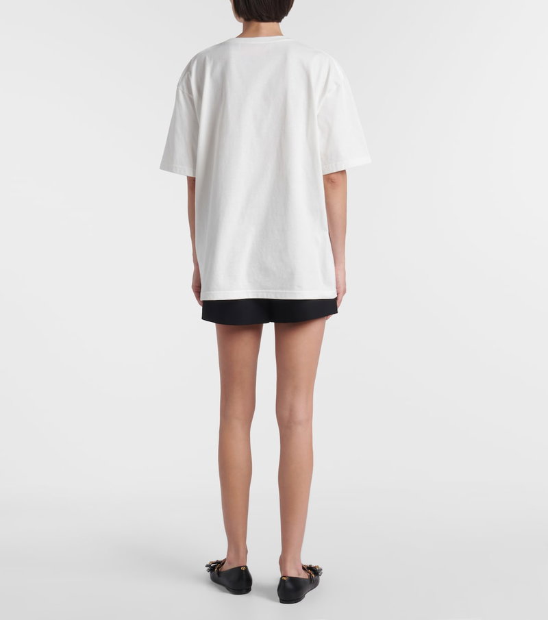 Valentino white t-shirt with black shorts and shoes