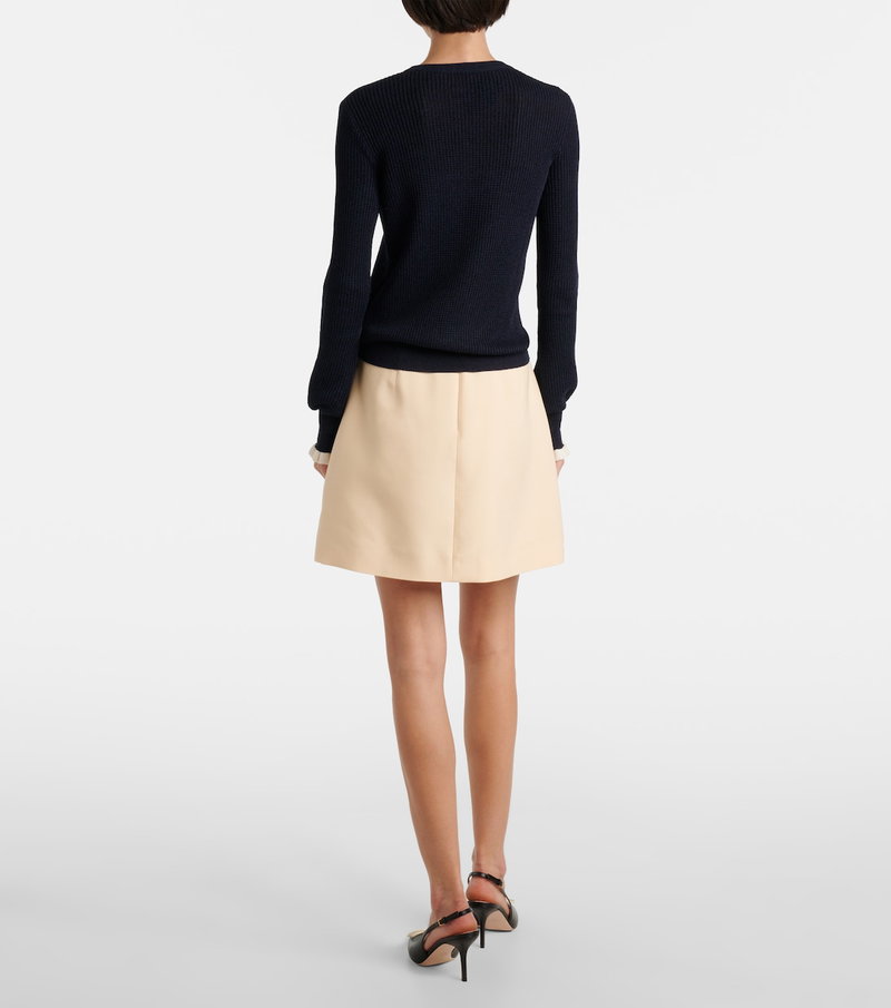 Dark navy ribbed sweater and beige A-line skirt