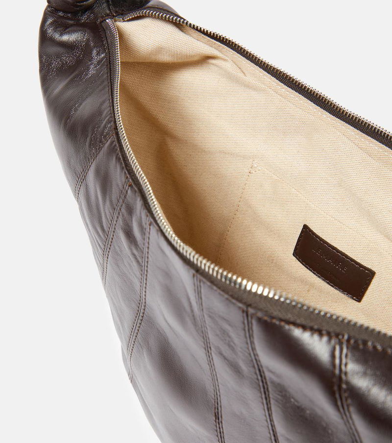 Dark brown leather tote bag with an open interior view.