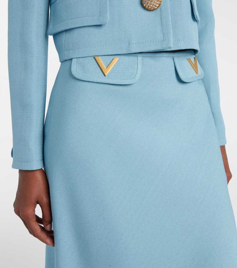 Light blue linen skirt with gold V logo and button detail