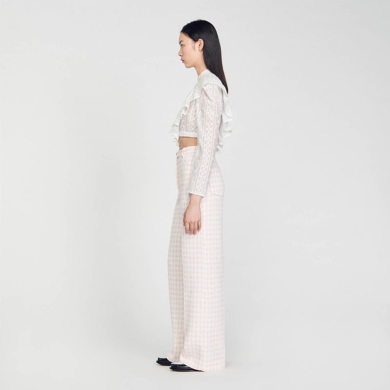 White lace crop top with pink gingham trousers