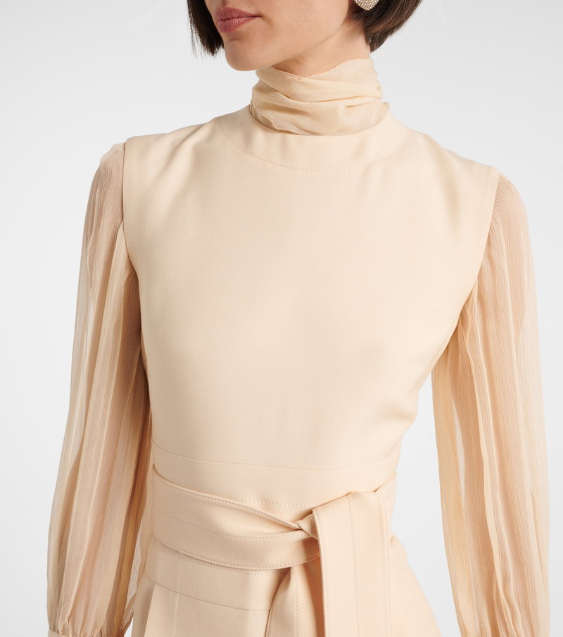 Cream-colored Valentino silk blouse with long sleeves and sheer panel detailing.