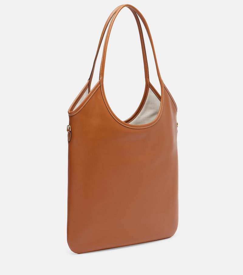 Brown leather tote bag with a curved handle and stitched interior.