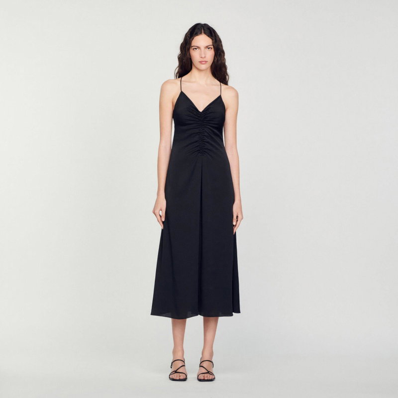 Black satin midi dress with ruched bodice and spaghetti straps.