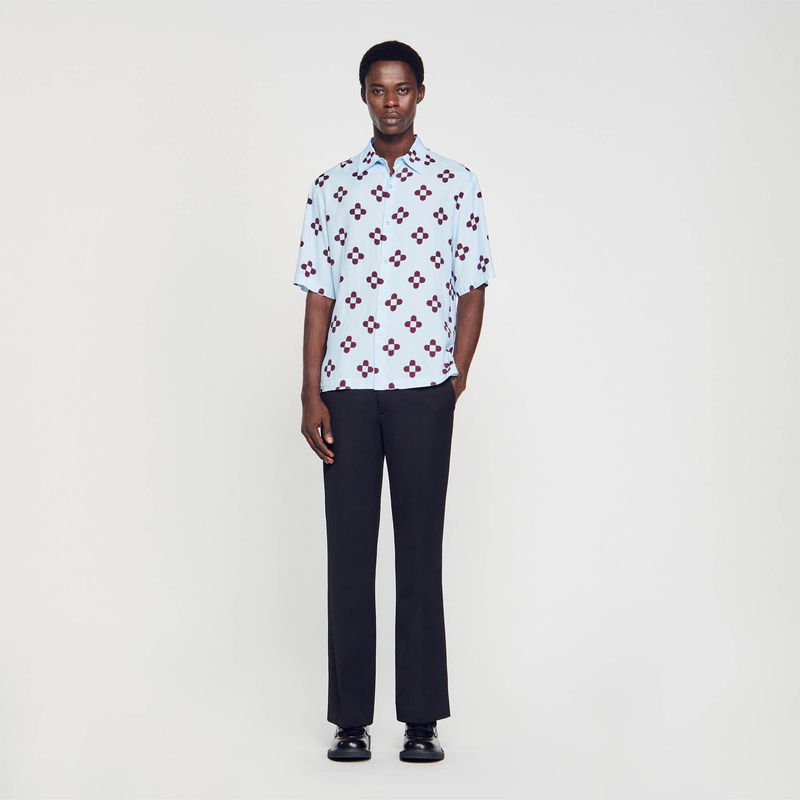 SANDRO - Man in blue and burgundy floral shirt with black trousers