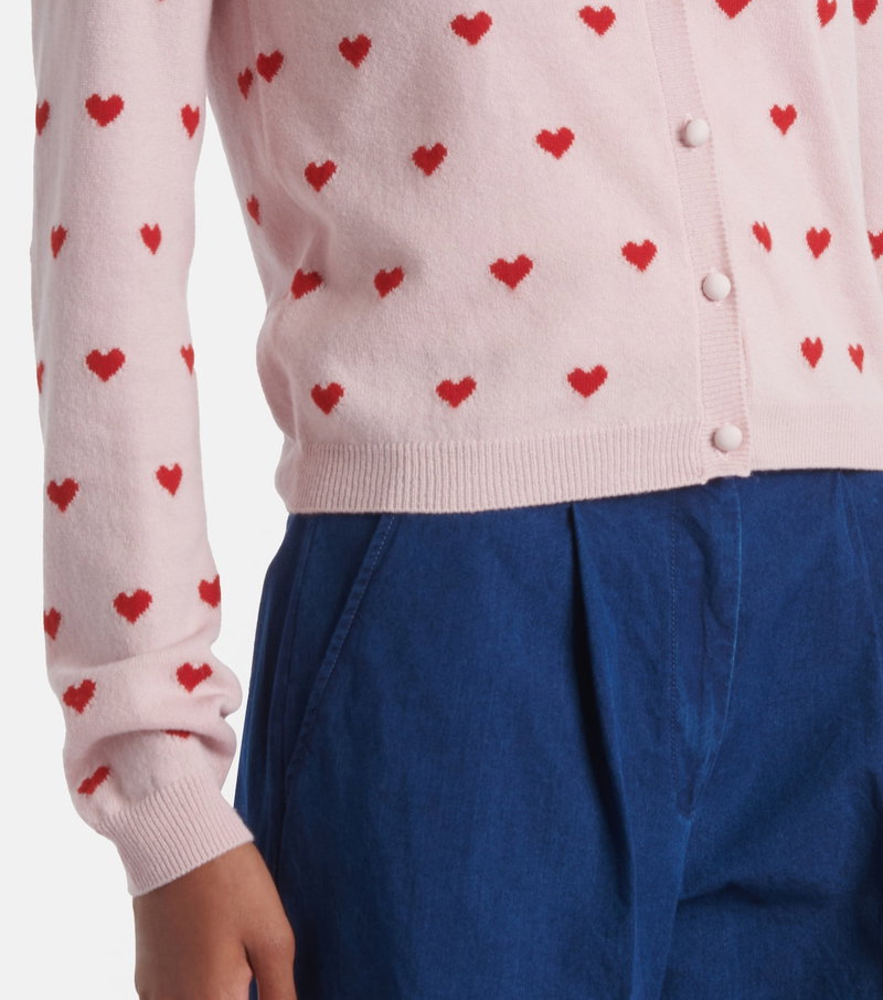 Pink cardigan with red heart embroidery, paired with blue corduroy pants.