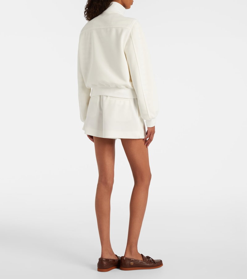 Valentino cream-colored cropped jacket and matching mini skirt.