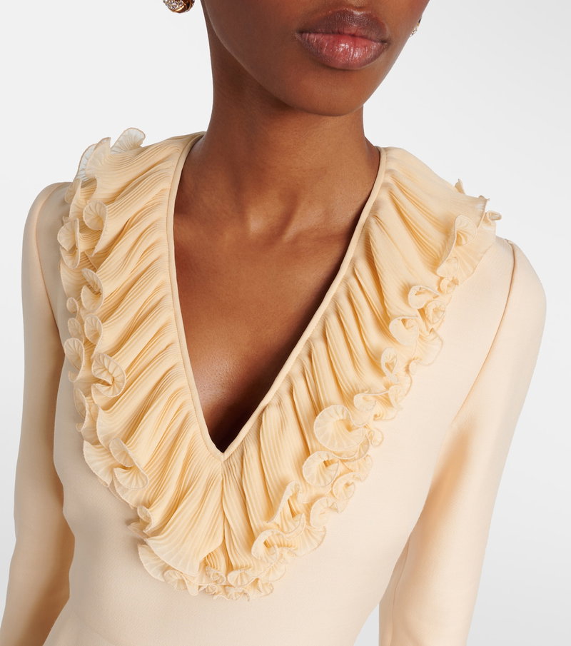 Cream-colored Valentino dress with ruffled neckline.