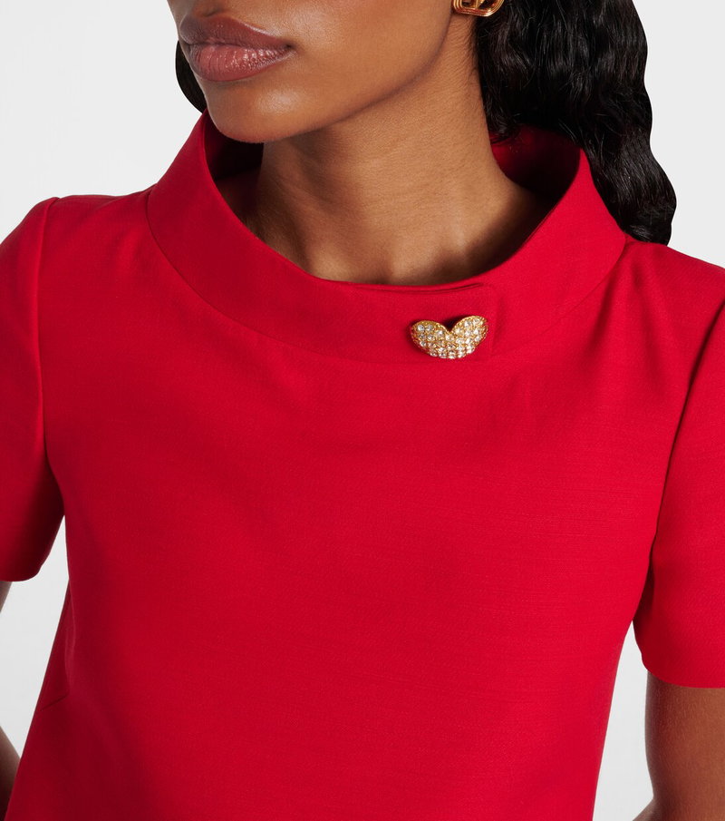 Red Valentino shirt with a gold heart brooch.