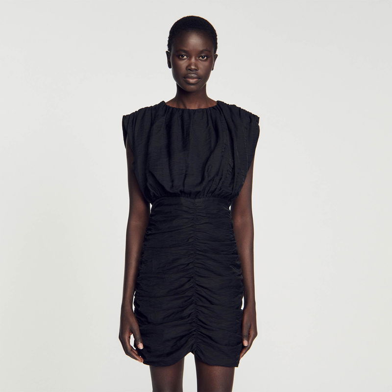 Black ruched midi dress with padded shoulders.