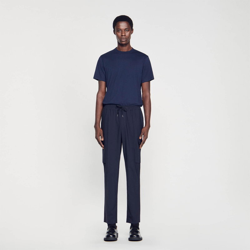 Man in a navy t-shirt and cargo pants.