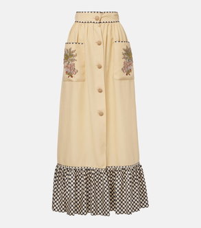 Embroidered, cream-colored high-waisted skirt with black and white polka dot hem.