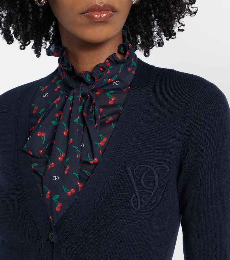 Dark blue cardigan with a cherry print silk scarf and embroidered logo.