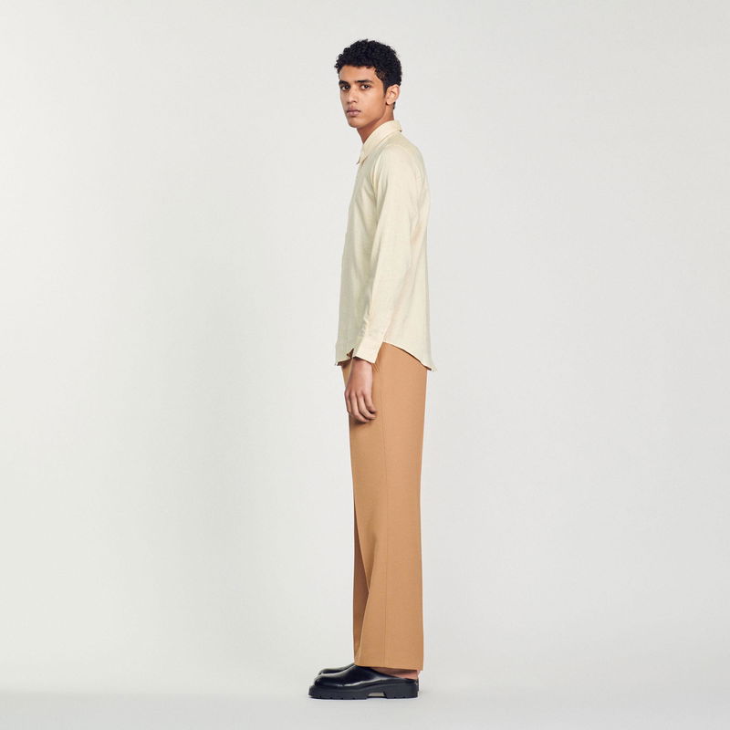 Sandro - Man in beige shirt and brown trousers