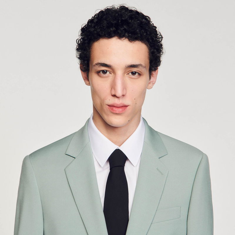 Man in light green suit and white shirt.