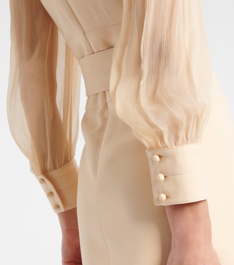 Cream silk blouse with puffed sleeves and buttoned cuffs