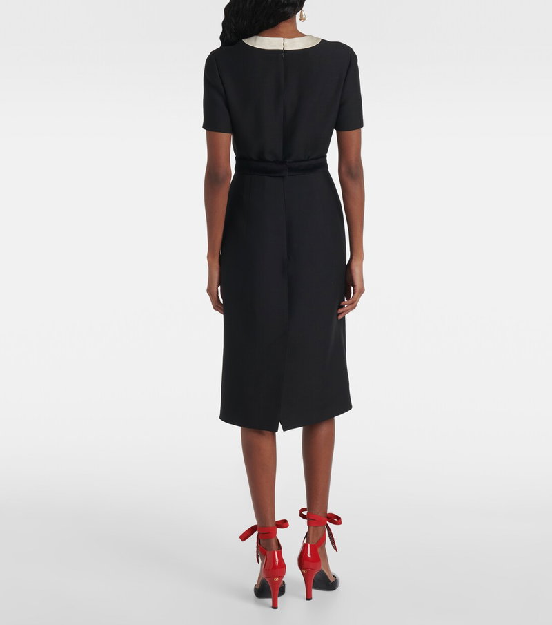 Black sheath dress with red detailing and tied heels