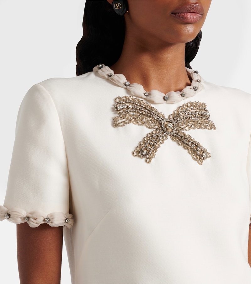 Valentino cream sweater with embellished bow and beaded cuffs.